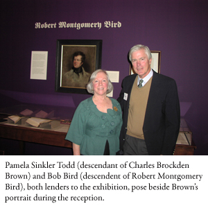 Pamela Sinkler Todd (descendant of Charles Brockden Brown) and Bob Bird (descendent of Robert Montgomery Bird), both lenders to the exhibition, pose beside Brown’s portrait during the reception.