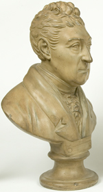 Sculpted bust of white man with short curly hair and wearing a coat with ruffled cravat.