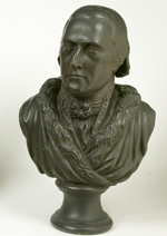 Sculpted bust of white man wearing a fur trimmed robe and cravat.