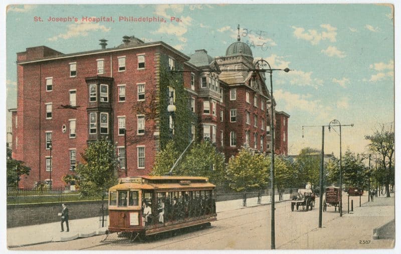 Color postcard depicting St. Joseph's Hospital with a trolley in the foreground.