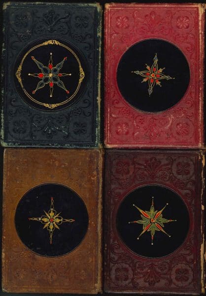 Back covers of Leavitt & Allen gift books with papier-mâché medallions.