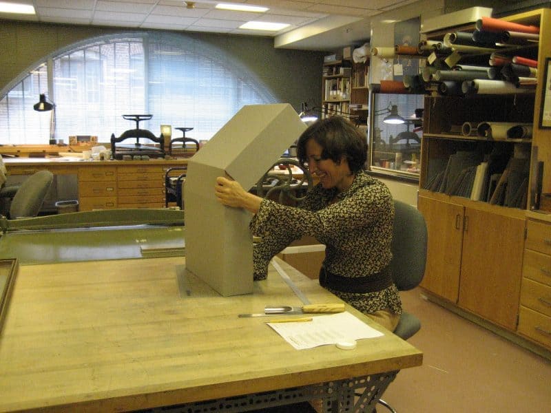 Conservator Andrea Krupp building a custom clamshell box.