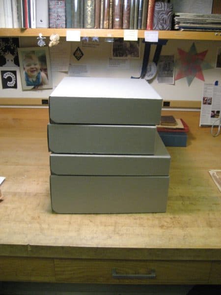 Four custom clamshell boxes, designed to fit four rare books.