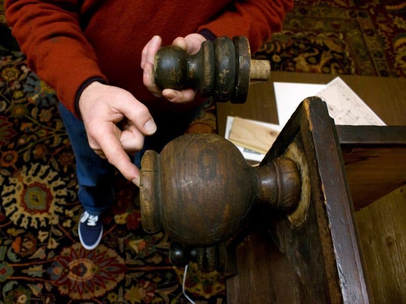 The original foot is placed back on the desk. Desks made during this time period had large ball feet. Compare it to the much smaller “restoration” foot above.