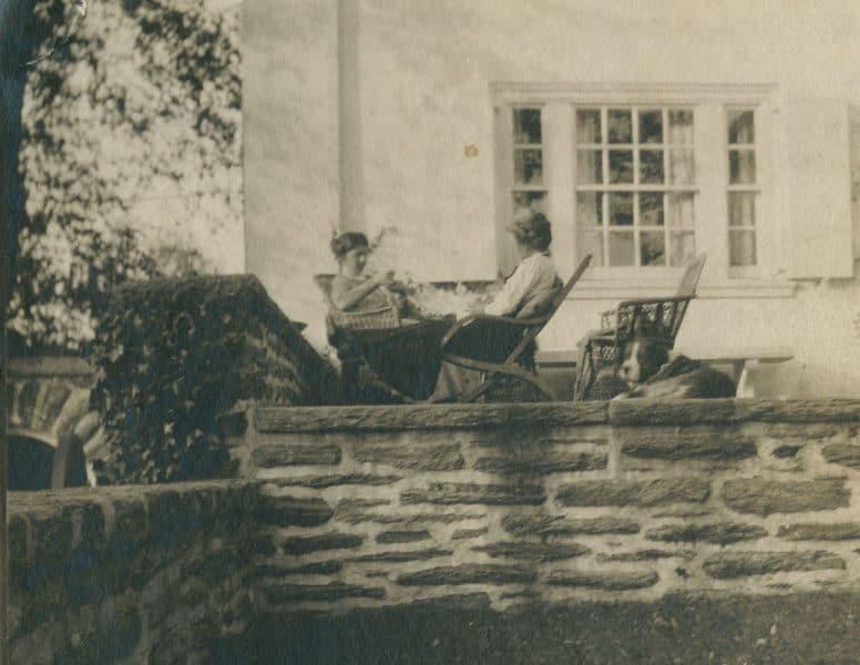 Oakley and Cozens enjoy a cup of tea together while sitting on the terrace at Cogslea with the family dog, Prince, seated behind Cozens.