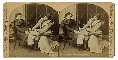 Stereograph depicting two women dressing one another.