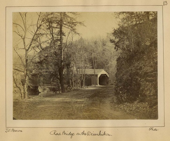 Photographic print of covered bridge.
