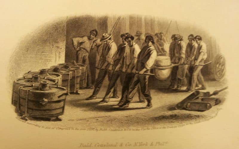Print depicting a factory scene. Many men are depicted, though it's hard to tell exactly what they're doing.