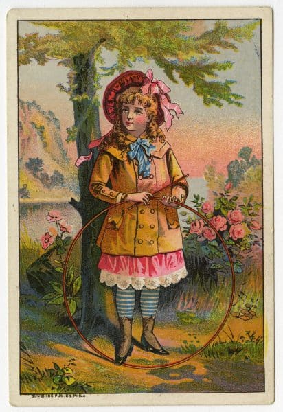 Trade card depicting a girl in a colorful outfit holding a hoop and stick.