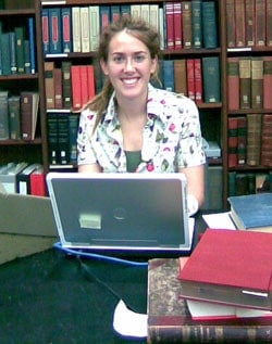 Intern Madeline Carlson at a laptop computer.