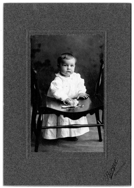 Portrait of Elliston Morris Jr. as a baby, wearing a long white dress.