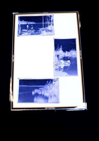 Three photographic negatives on a lightbox.