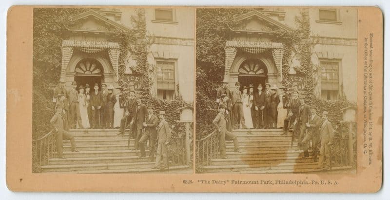 Stereograph depicting a group in front of an ice cream parlor.