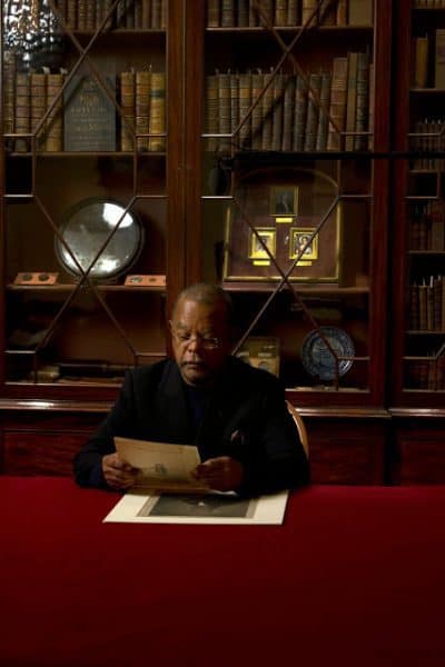 Henry Louis “Skip” Gates, Jr., Harvard University professor, author, and documentary host. He is seated and viewing a record.