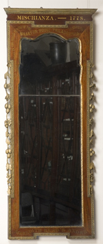 Tall wood-framed mirror with gilt decoration and inscriptions. 