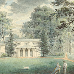 Two buildings with large windows stand within tree grove. Two women, one standing and one sitting, and a dog on green lawn in foreground