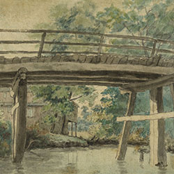 Close-up of planked wooden bridge from water level. House visible in background through wooden pylons