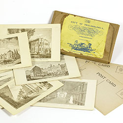 Group of postcards each printed with city view along with original packaging