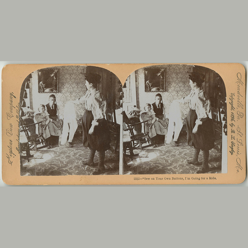 Double-sided photographs of a white woman in pants handing shirt to white man, holding a broom, and seated next to young girl in a parlor. One view has woman also gripping a bicycle. 