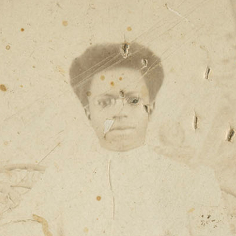 Faded portraits on torn mats depicting a full-length portrait and bust-length portrait of young African American women, their hair pulled back, and attired in blouses. 