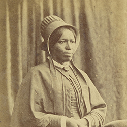 A standing portrait of a black woman