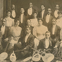 A black and white group portrait photograph with instruments