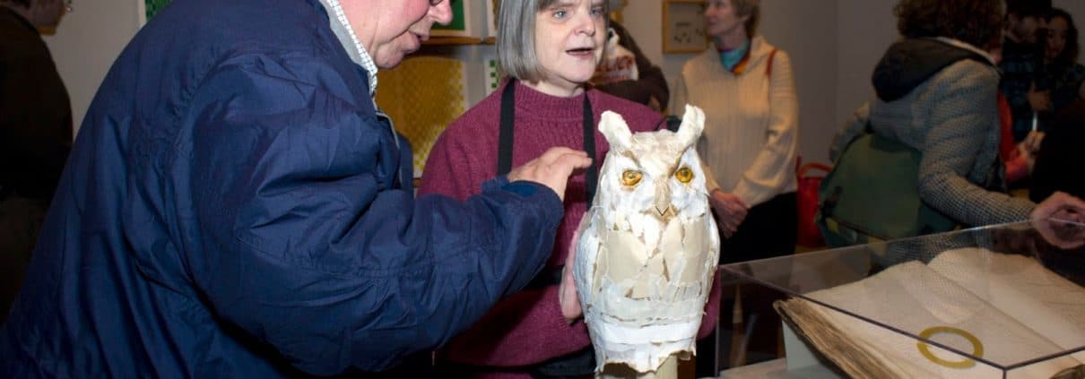 Reception, Common Touch: The Art of the Senses in the History of the Blind. Two visitors interact with a sculpture of an owl.