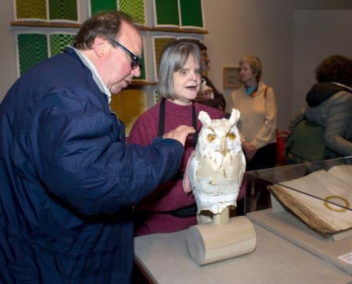 Reception, Common Touch: The Art of the Senses in the History of the Blind. Two visitors interact with a sculpture of an owl.