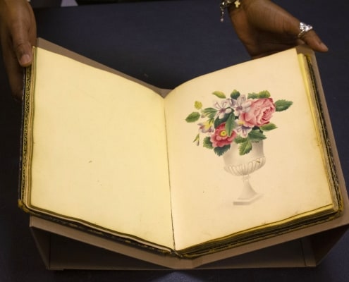 Jasmine Smith, LCP African American history subject specialist, holds a rare friendship album.