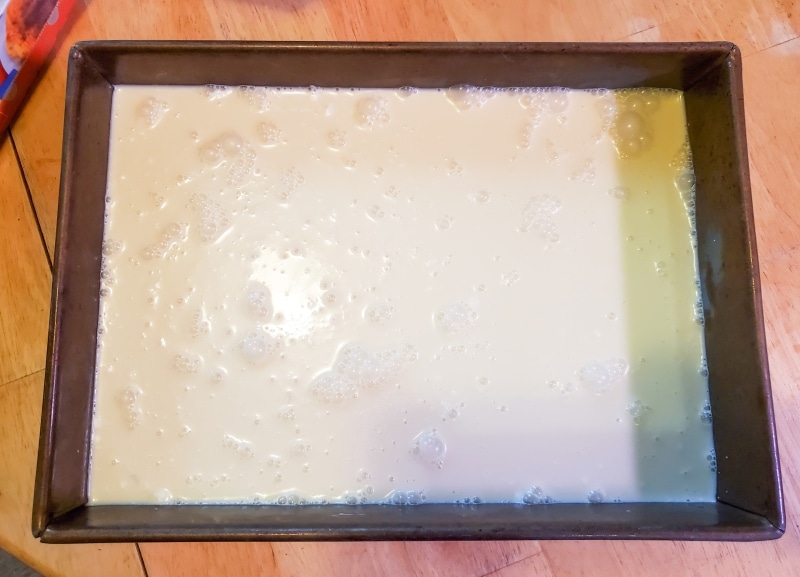 Metal pan filled with frozen cream.