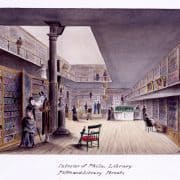 19th-century white men and women browse books in the two-story Library Company building. Bookshelves line the walls. One man sits reading.