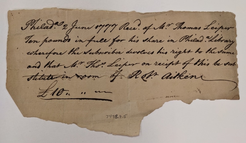 Photograph of scrap of paper with handwritten receipt for 1777 transfer of share from Robert Aitken to Thomas Leiper