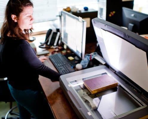 Concetta Barbera, Digital Outreach Librarian and Curatorial Assistant, scanning a book in the Library Company Digitization Department.