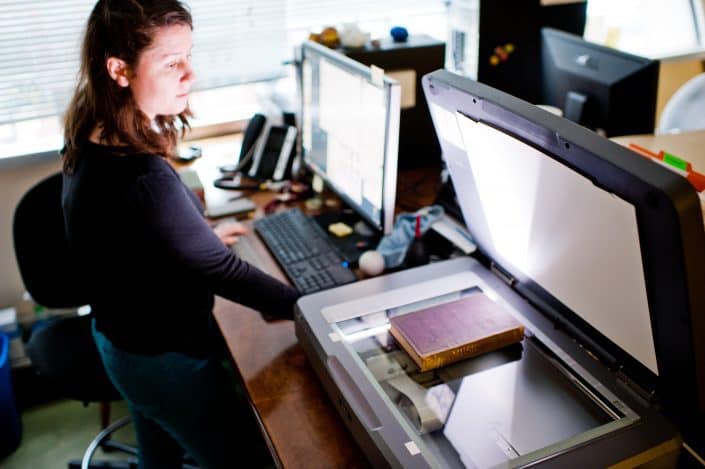 Digitization Department Concetta Barbera, Digital Outreach Librarian and Curatorial Assistant, scanning a book in the Library Company Digitization Department.