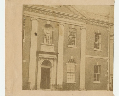 Photograph of front exterior of Library Company building with statue in niche above front door