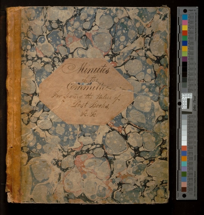 Photograph of cover of bound volume titled Minutes of the Committee for Fixing the Value of Lost Books