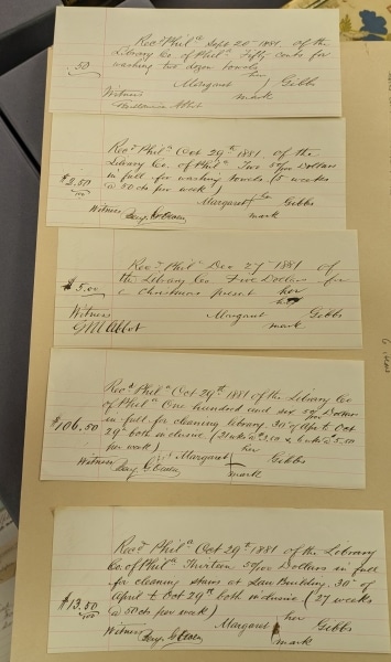 Photo of several handwritten receipts on a table