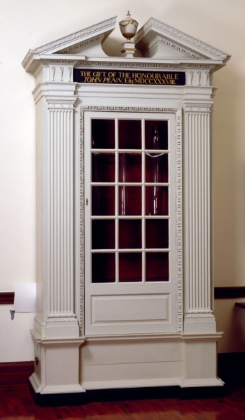 Photograph of tall white palladian-style cabinet for storing the Library Company's air pump