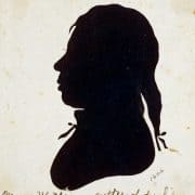 19th-century silhouette of Black man artist Moses Williams facing left wearing bows on ponytail and collar.
