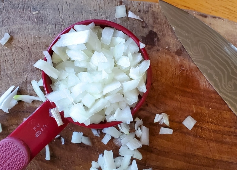 Four tablespoons of diced onion measured.