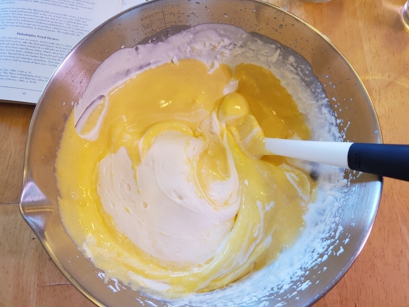 Folding the eggs and sugar into the whipped cream