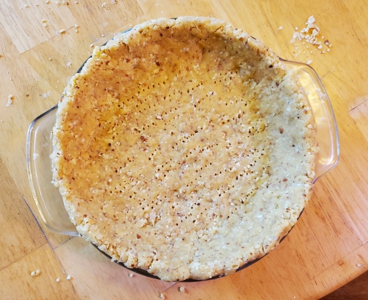 Almond dough spread in baking dish and ready to fill